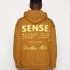 HOODIE BERLIN UNISEX - Kapuzenpullover - Brown -Herrenbekleidung 7d759abebae7477f950af63ee4f45434